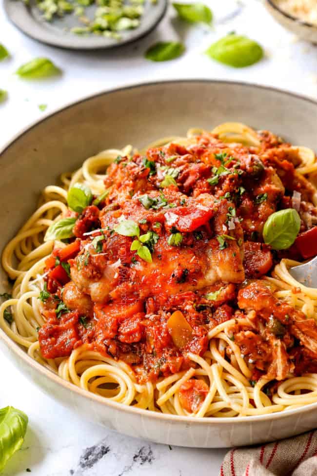 chicken cacciatore recipe in a bowl over pasta