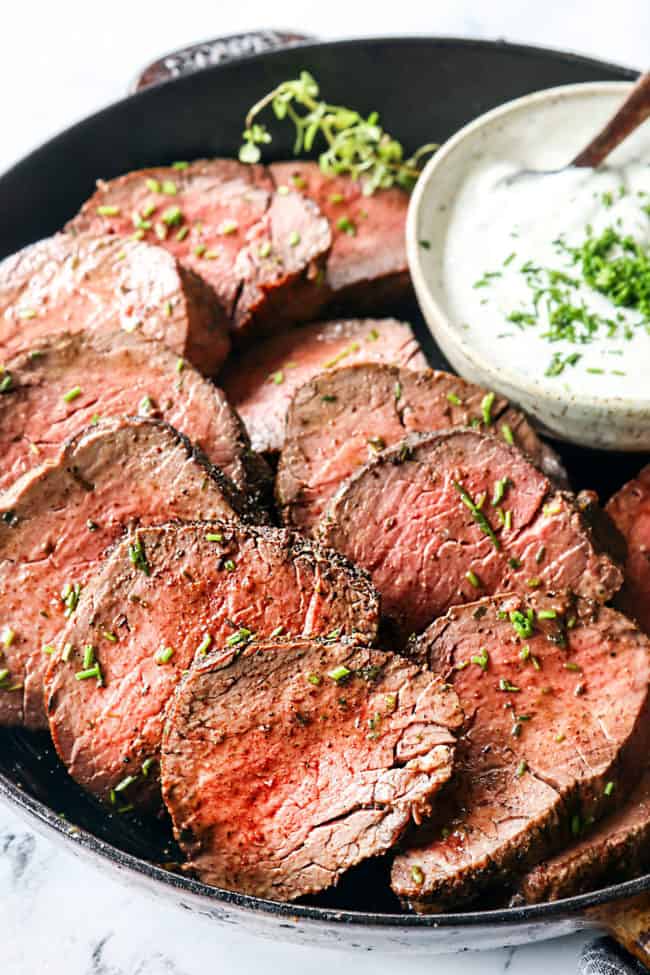 beef tenderloin recipe in a cast iron skillet with horseradish cream sauce