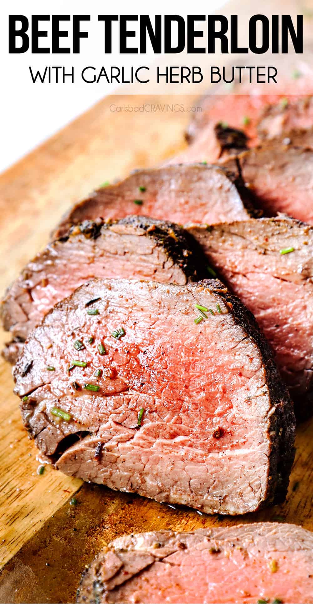 up close of beef tenderloin sliced in a wood cutting board 