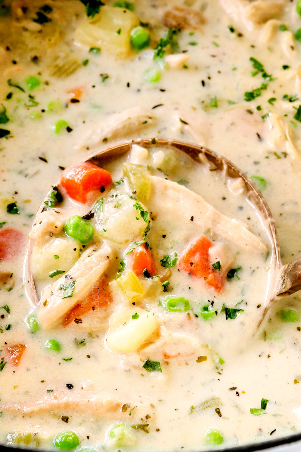 up close of a ladle of chicken pot pie soup from scratch without cream of chicken soup