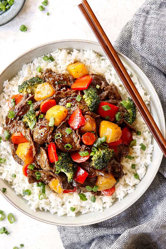 top view of beef teriyaki served over rice with chopsticks