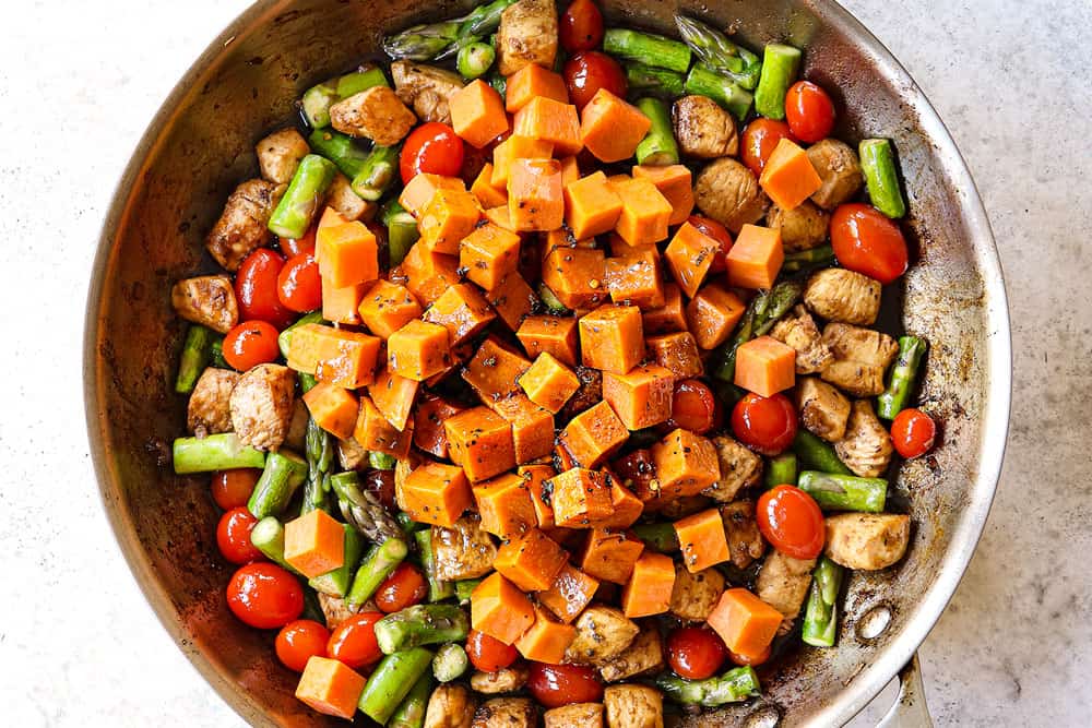 howing how to make balsamic chicken by adding sweet potatoes and balsamic sauce to the balsamic chicken inn the skillet