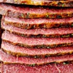 showing how to make corned beef by slicing against the grain on a cuttiing board