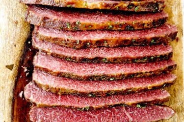 showing how to make corned beef by slicing against the grain on a cuttiing board