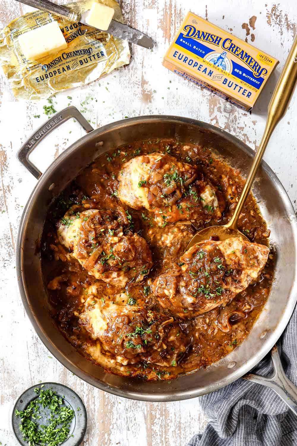 top view of French onion chicken in a skillet with chicken and Gruyere cheese