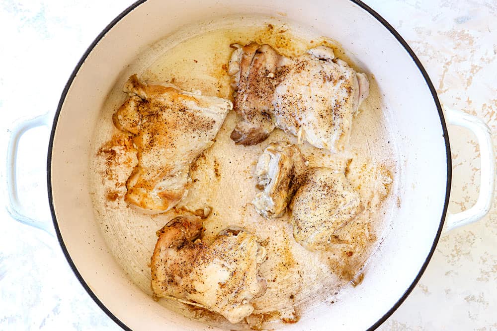 showing how to make buffalo chicken chili by searing chicken in a Dutch oven