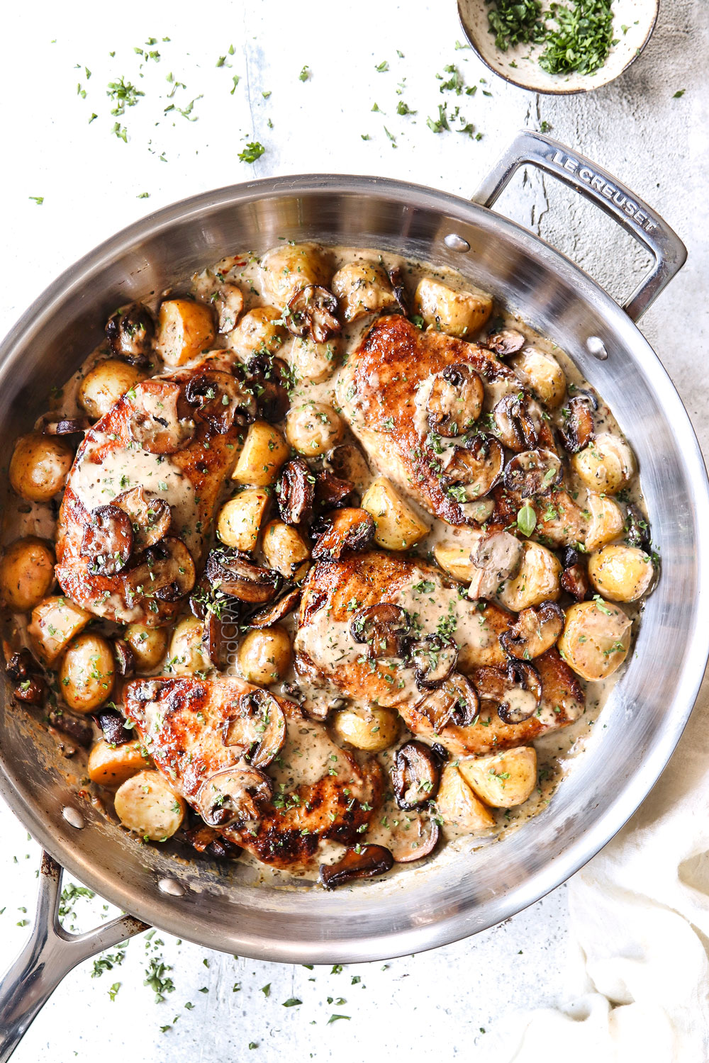 showing how to make Chicken mushroom recipe by by adding chicken back to the mushroom cream sauce