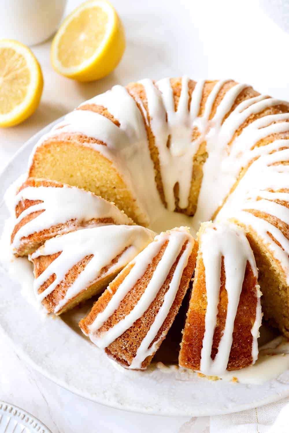 lemon pound cake on a platter sliced with lemon glaze for cake