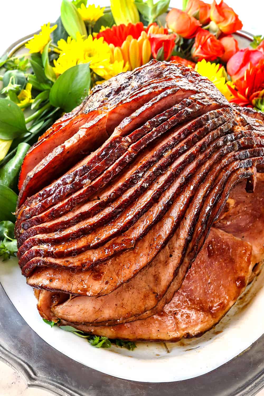 showing how to make ham glaze recipe with brown sugar and pineapple by letting the ham rest on a platter after baking