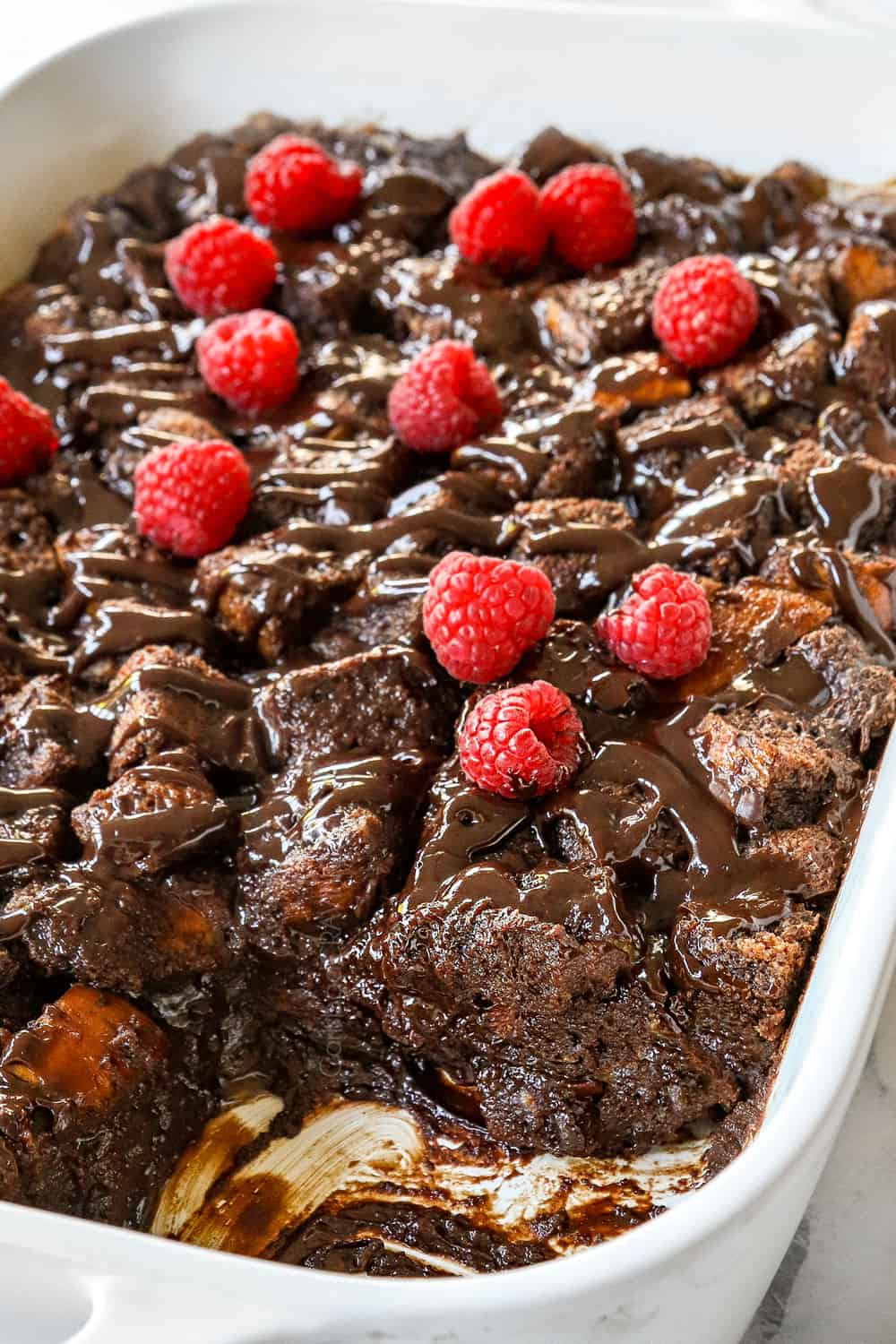 up close of bread pudding with a slice removed from the pan to see how creamy it is