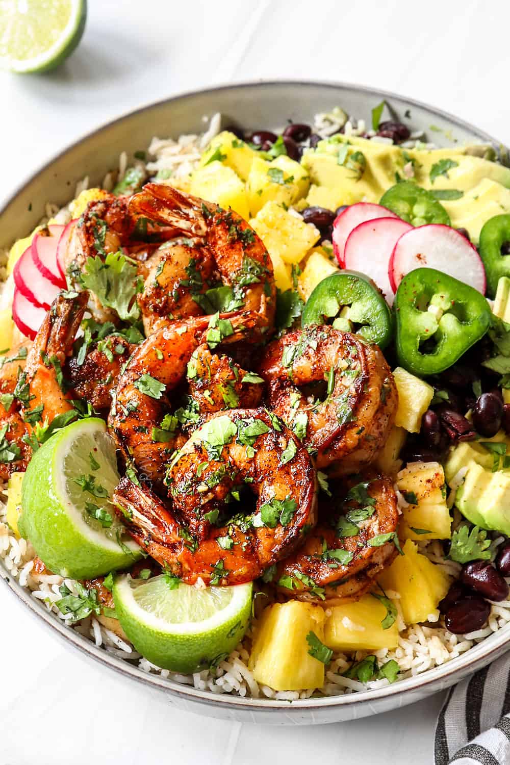 cilantro lime shrimp in a bowl garnished with cilantro and lime