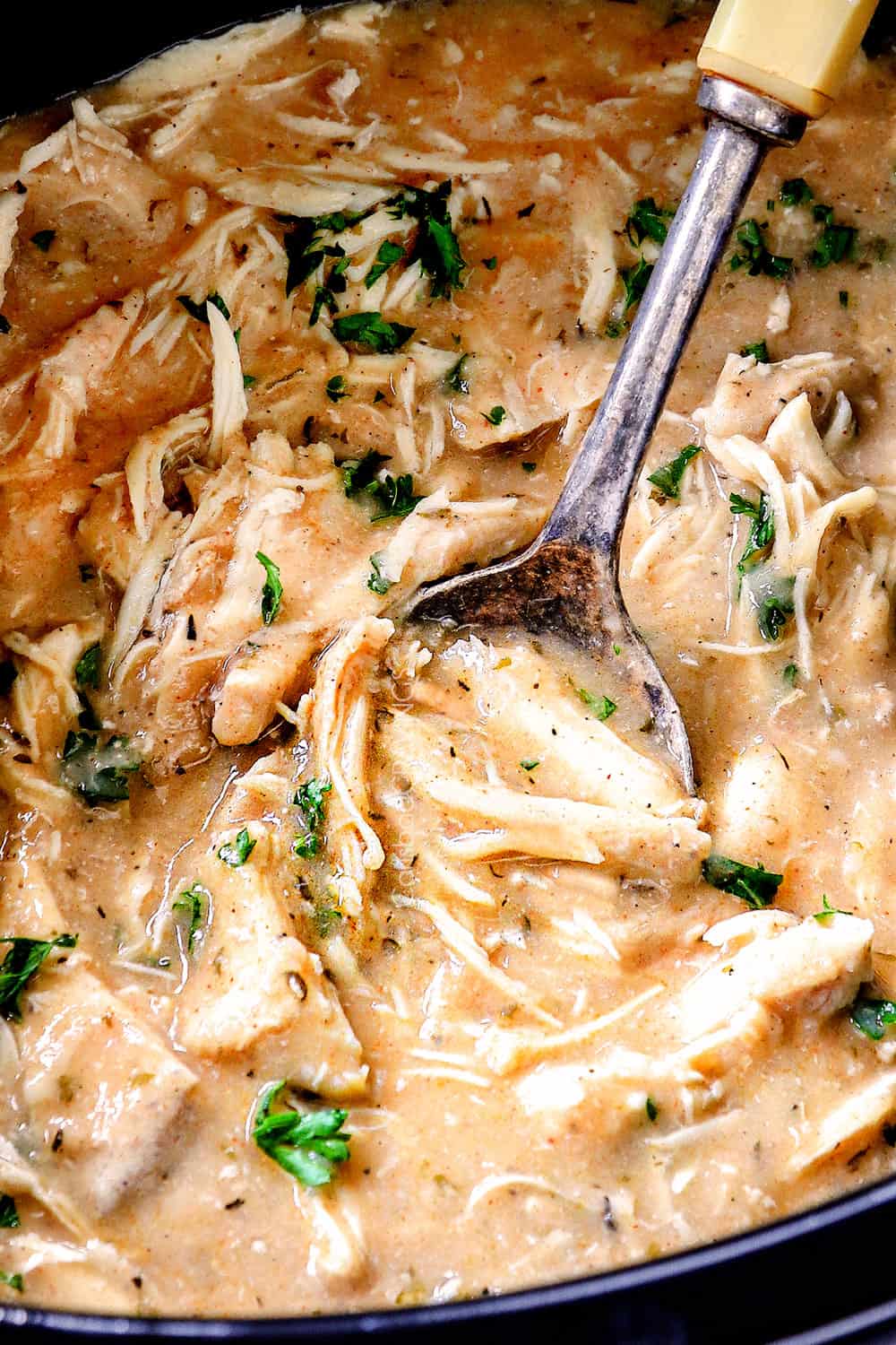 up close a spoon scooping up chicken and gravy recipe in the crockpot