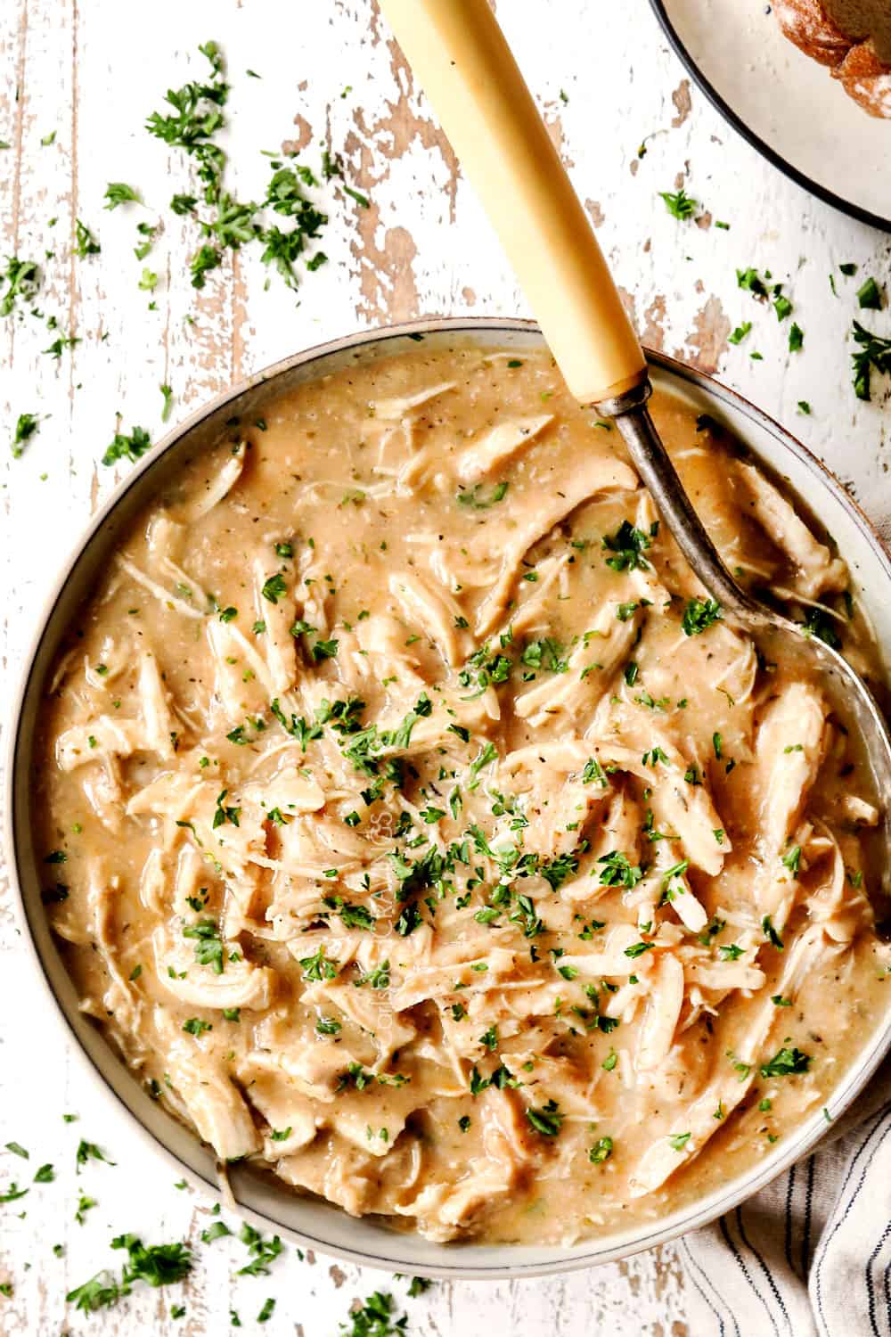 top view of chicken and gravy recipe in a bowl with a serving spoon