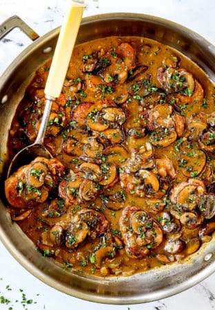 up close showing how to serve pork medallion recipe by serving over mashed potatoes garnished with parsley