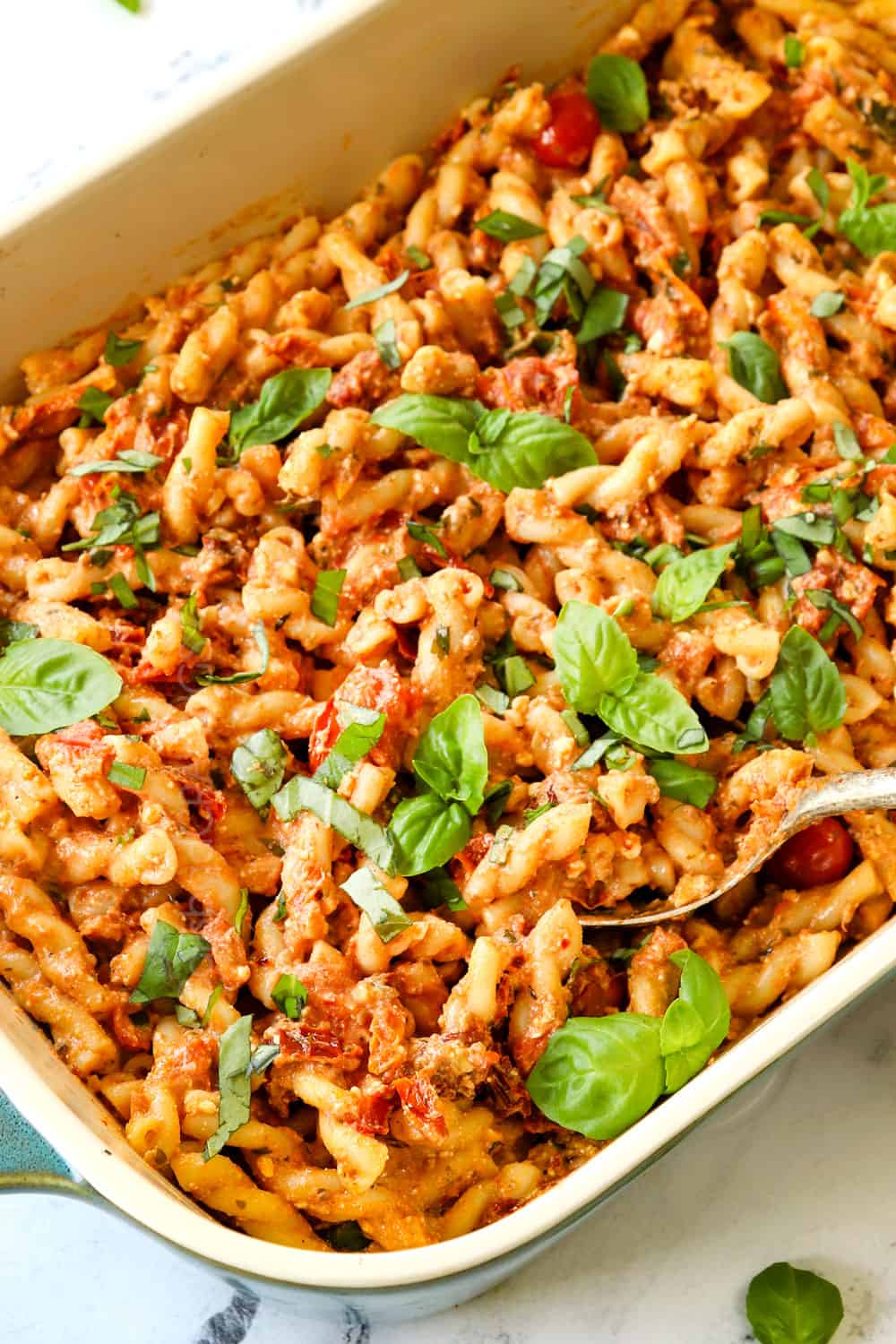 a spoon picking up Baked Feta Pasta recipe showing how creamy it is