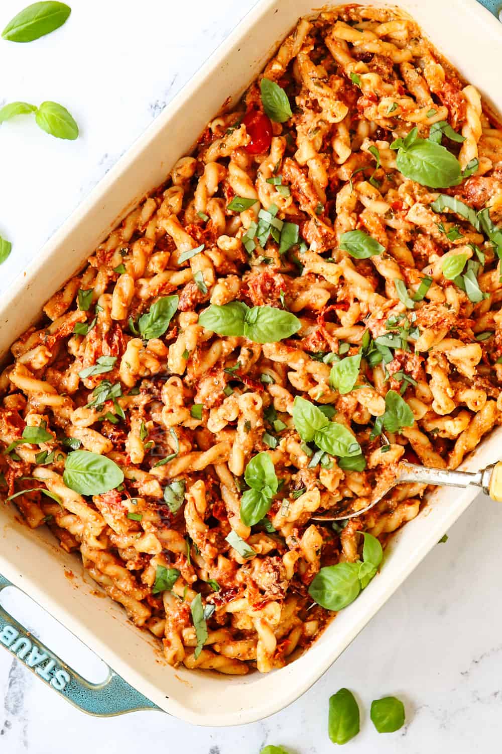 top view of TikTok Feta Pasta in a 9x13 baking dish garnished with basil