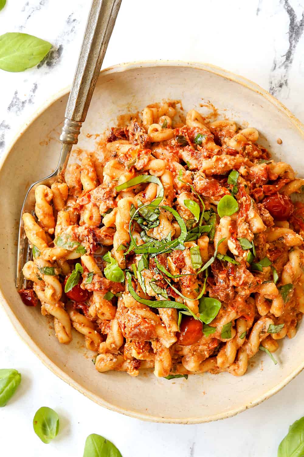 top view of Feta tomato Pasta TikTok on a plate garnished with fresh basil