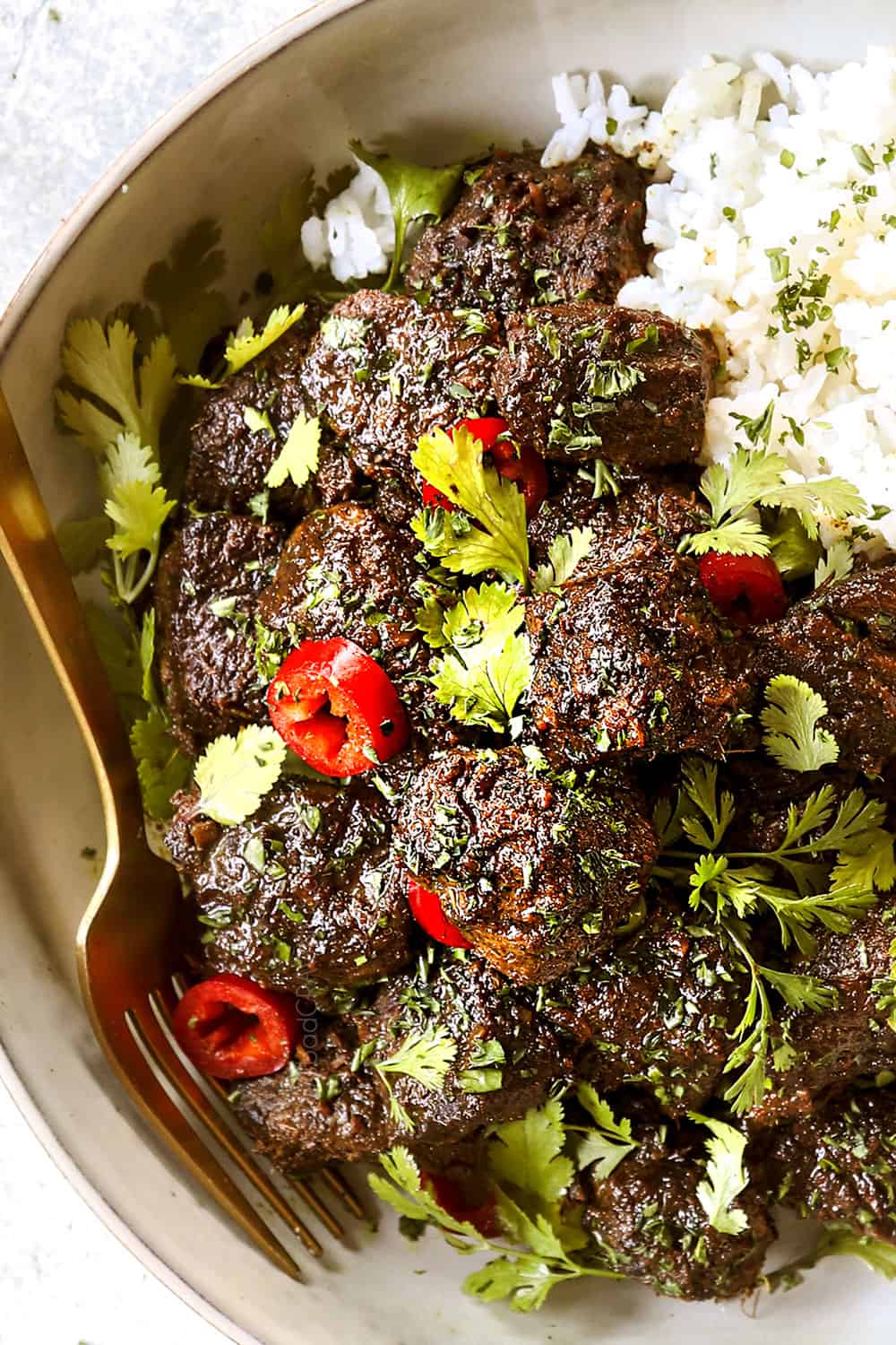 top view of beef rendang in a white bowl