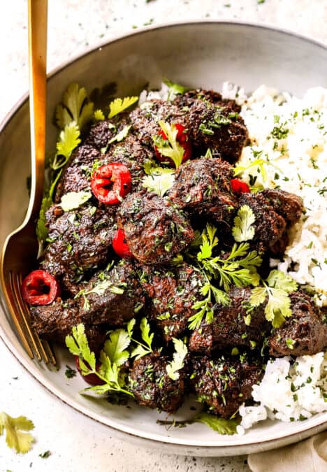 showing how to serve beef rendang by adding to a bowl with rice