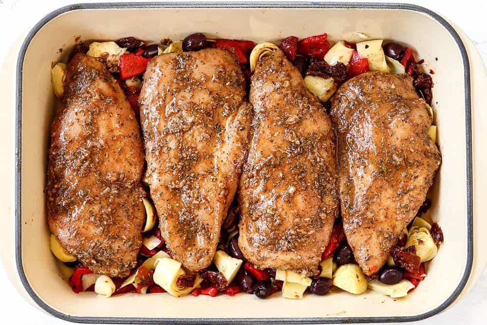 showing how to make Greek chicken by adding Greek chicken to baking dish