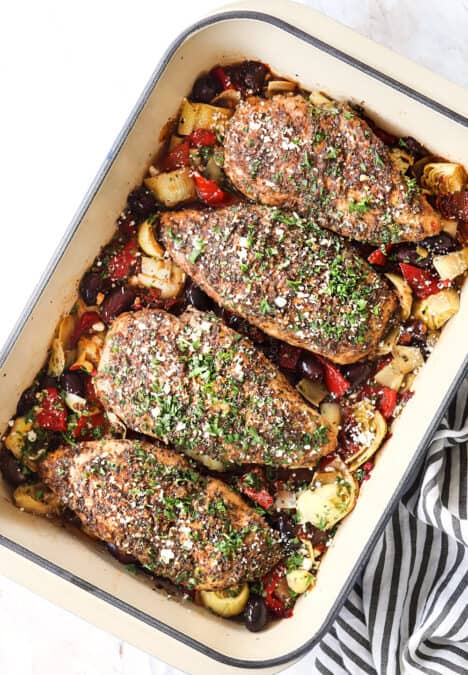 top view of Greek chicken garnished with feta and parsley