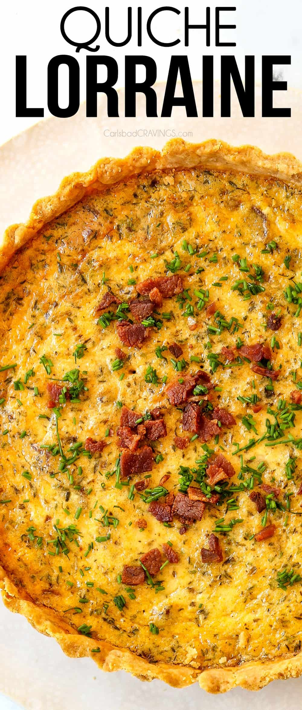 top view of Quiche Lorraine garnished with bacon and chives on a white plate
