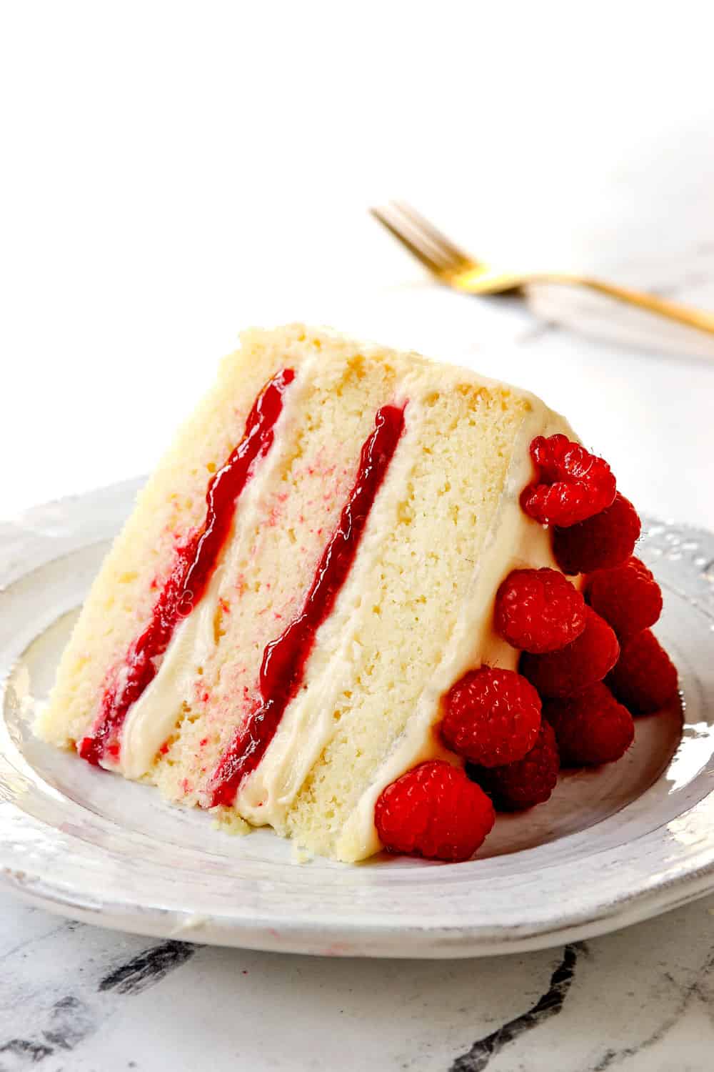 a slice of white chocolate raspberry cake showing how tender it is