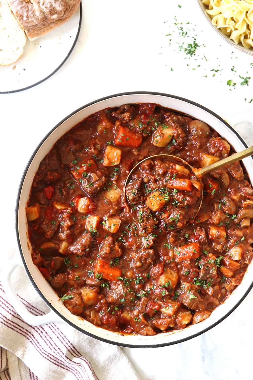 showing how to make goulash by garnishing with parsley