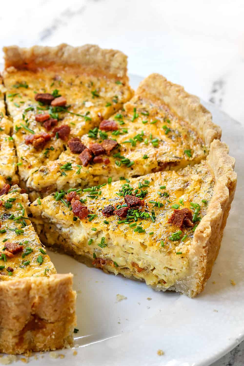 up close of a slice of the best Quiche Lorraine showing how creamy it is