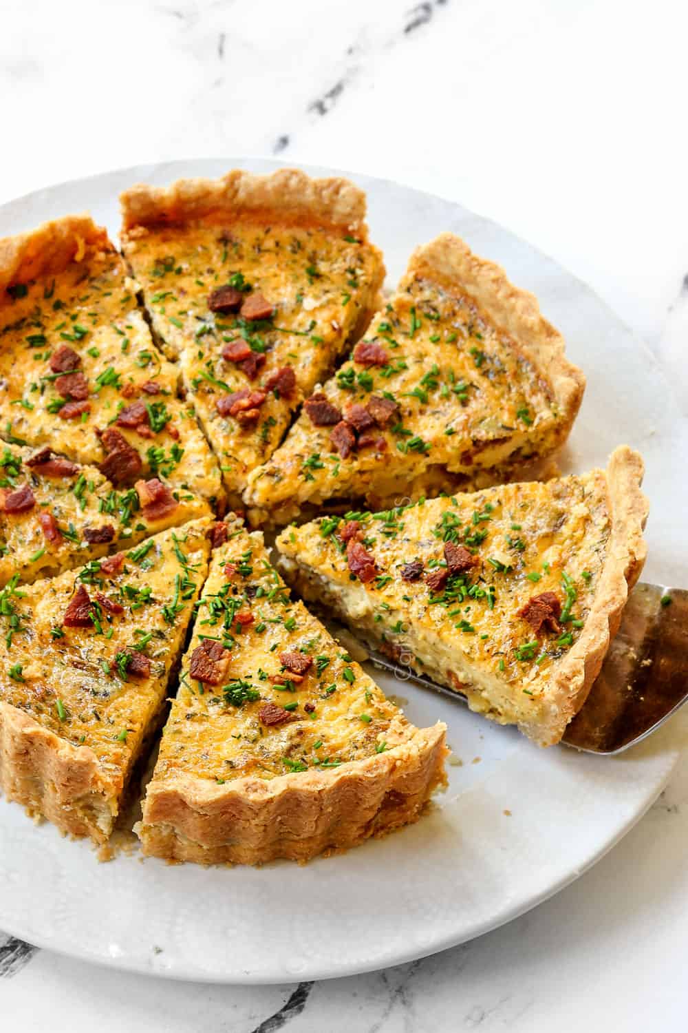 best Quiche Lorraine recipe sliced on a white plate