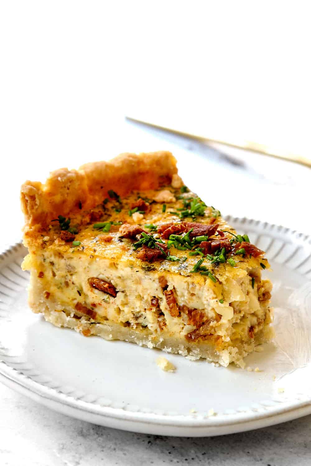 up close of best Quiche Lorraine with a bite taken out of it
