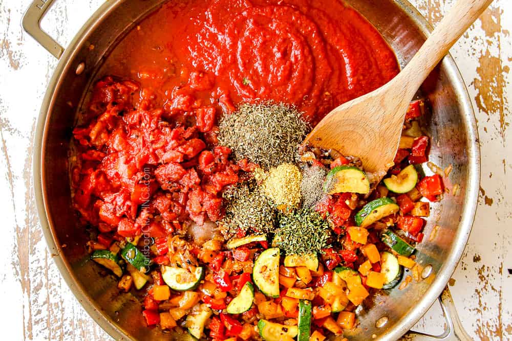 showing how to make shrimp pasta by adding crushed tomatoes, diced tomatoes and Italian seasonings