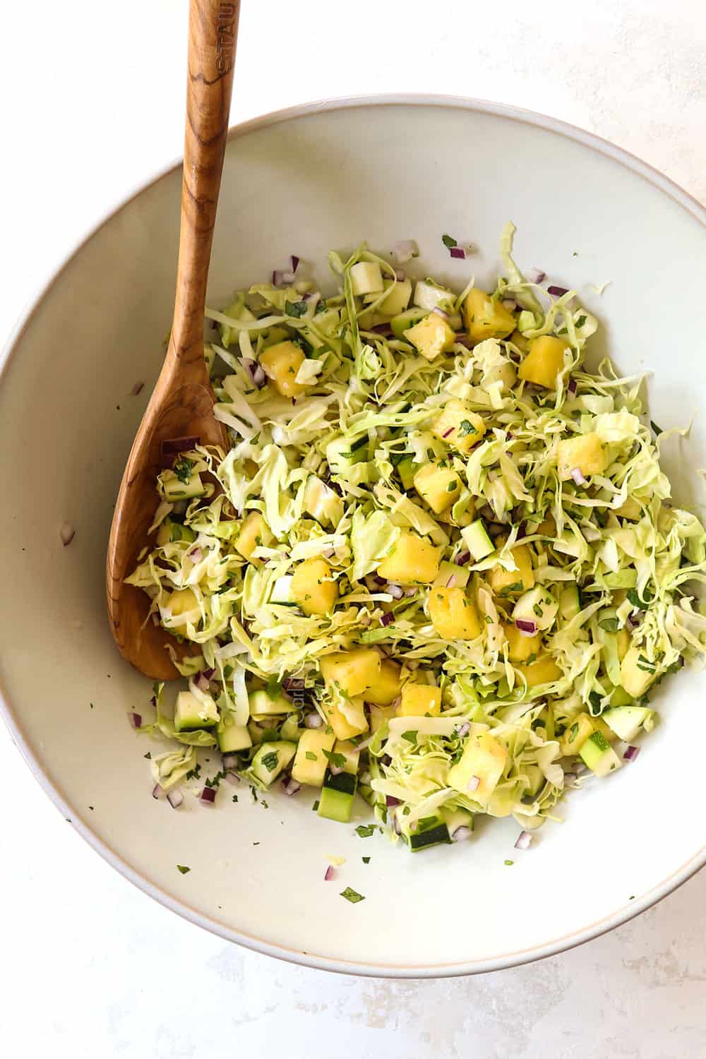 showing how to make slaw for shrimp tacos