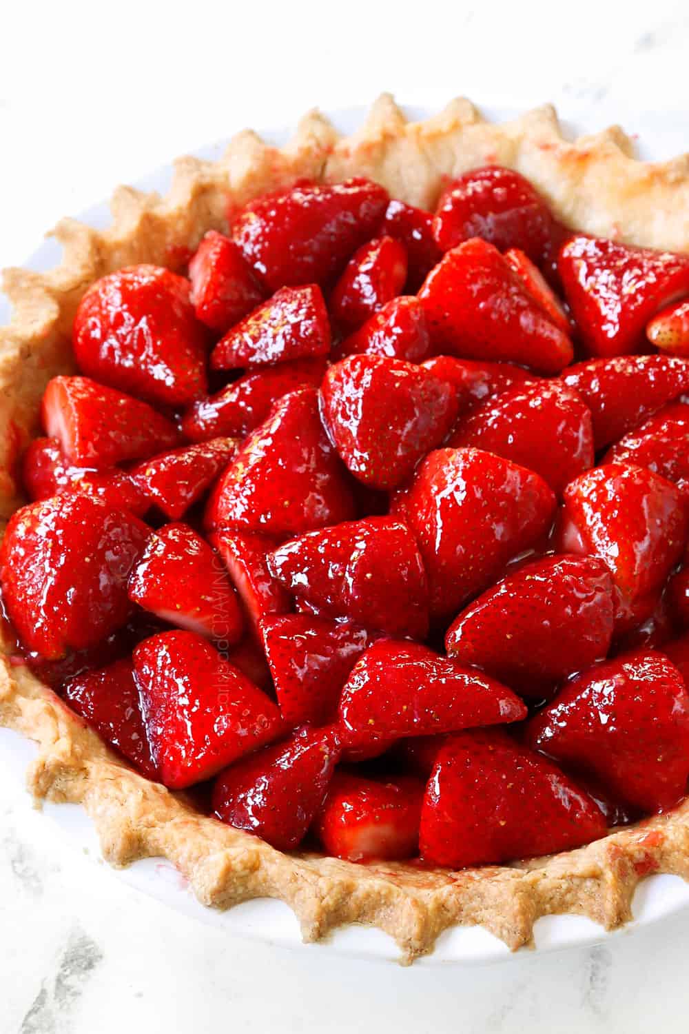 side view of strawberry pie recipe in a pie crust