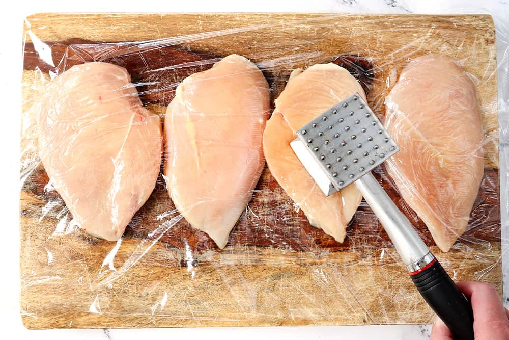 showing how to make blackened chicken Alfredo by pounding chicken fillets to an even thickness with meat mallet