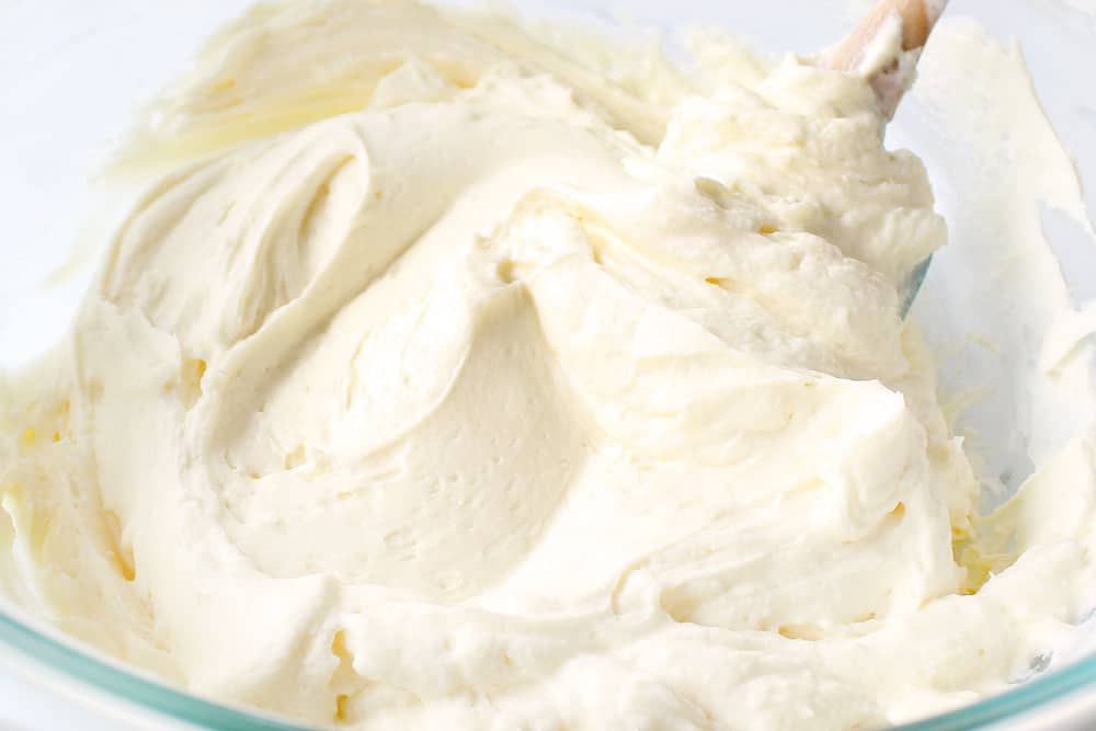 showing how to make cheesecake salad by folding cheesecake pudding into cream cheese mixture