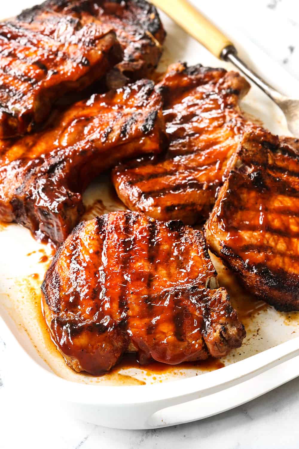 up close of grilled pork chops recipe showing how juicy they are