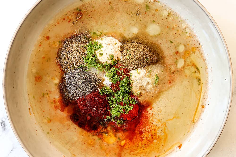 showing how to make grilled salmon marinade by whisking olive oil, lime juice, lime zest and seasonings togther