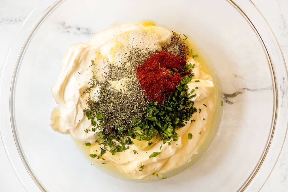 showing how to make potato salad by adding mayonnaise, sour cream, dill, parsley and chives