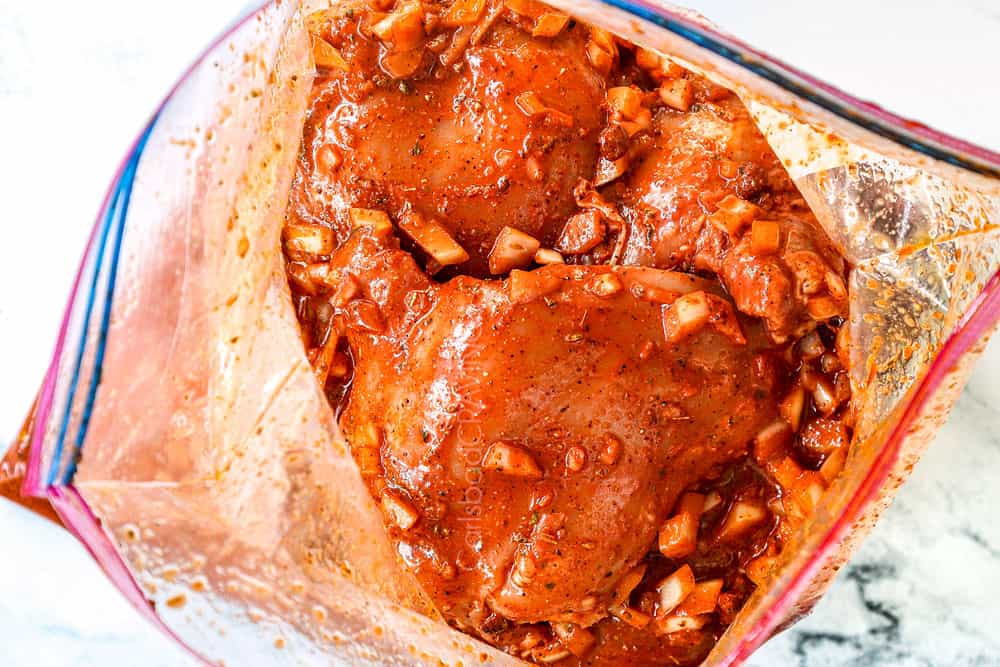 showing how to make pollo asado recipe by adding chicken to he marinade in a plastic bag