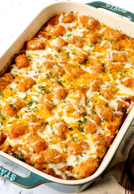 tater tot breakfast casserole covered with cheese and crispy tater tots