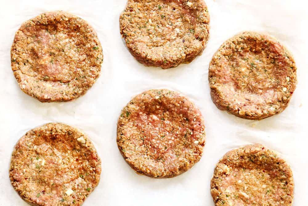 showing how to make lamb burger recipe Greek style by dimpling the patties