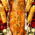 top view of grilled salmon in foil with grilled vegetables