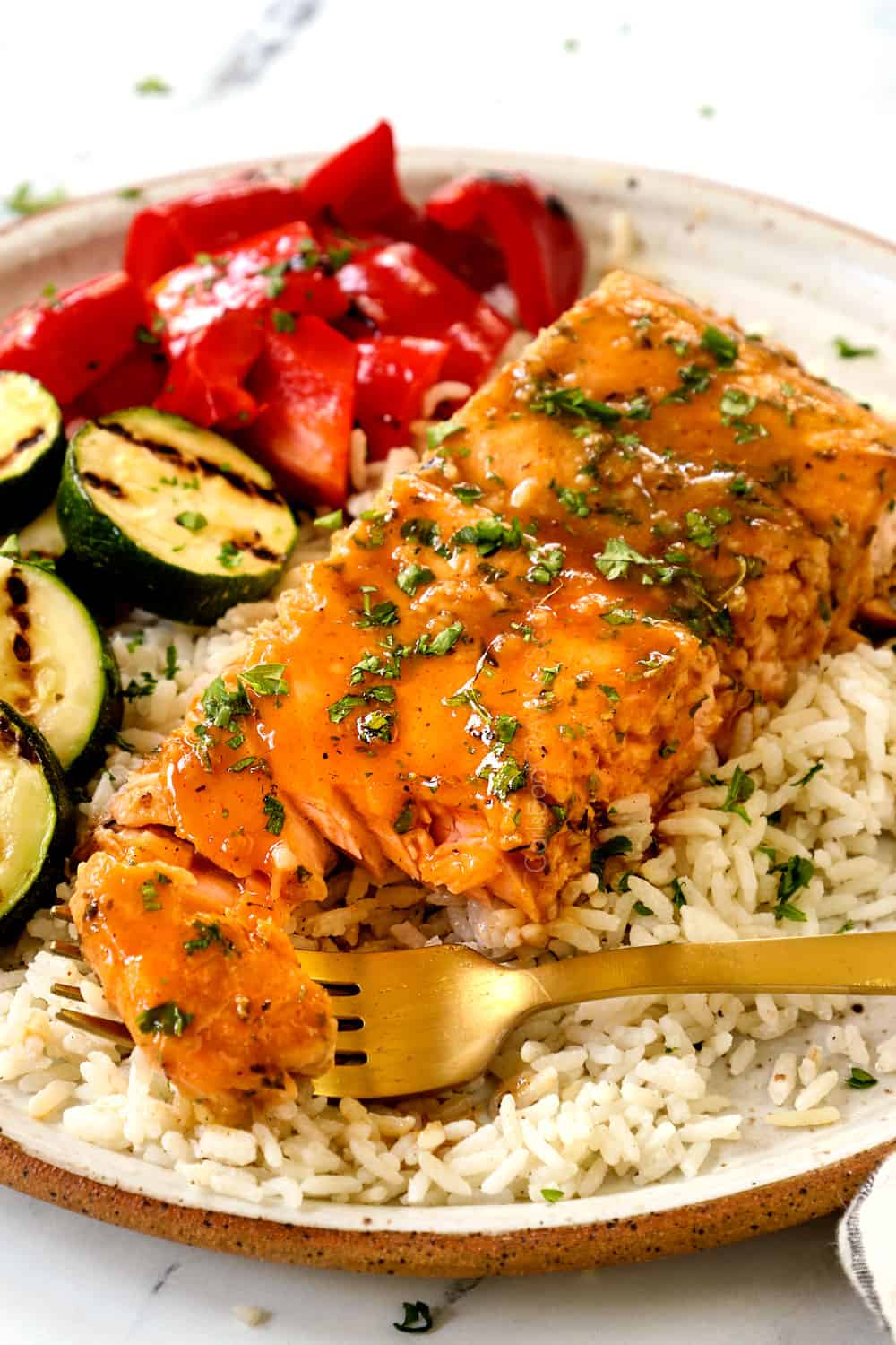 taking a forkful of grilled salmon in foil showing how juicy it is