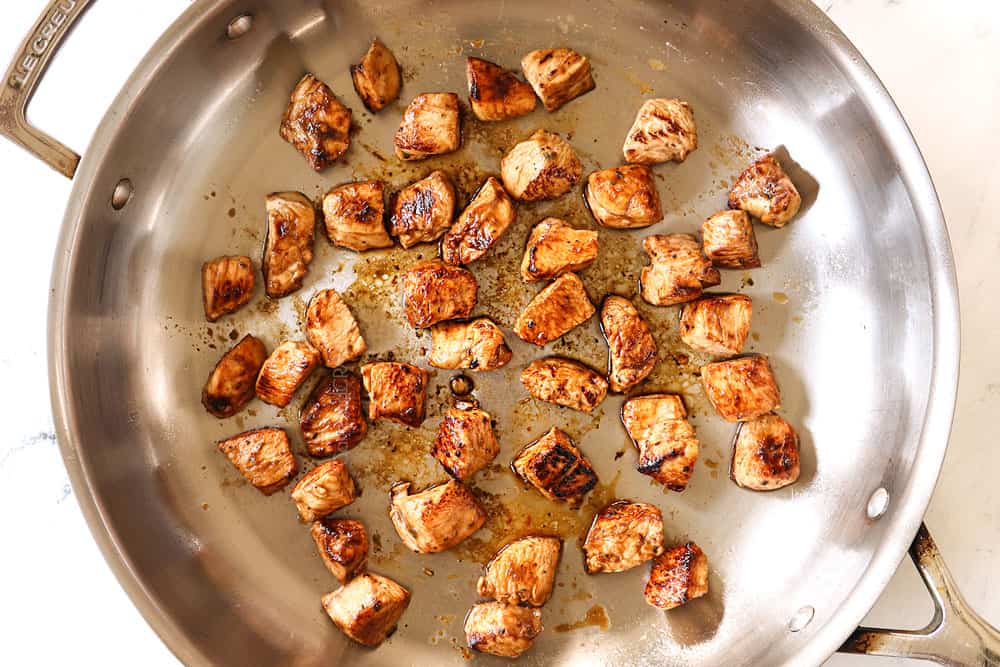 showing how to make bruschetta chicken pasta by cooking the chicken in a skillet until browned