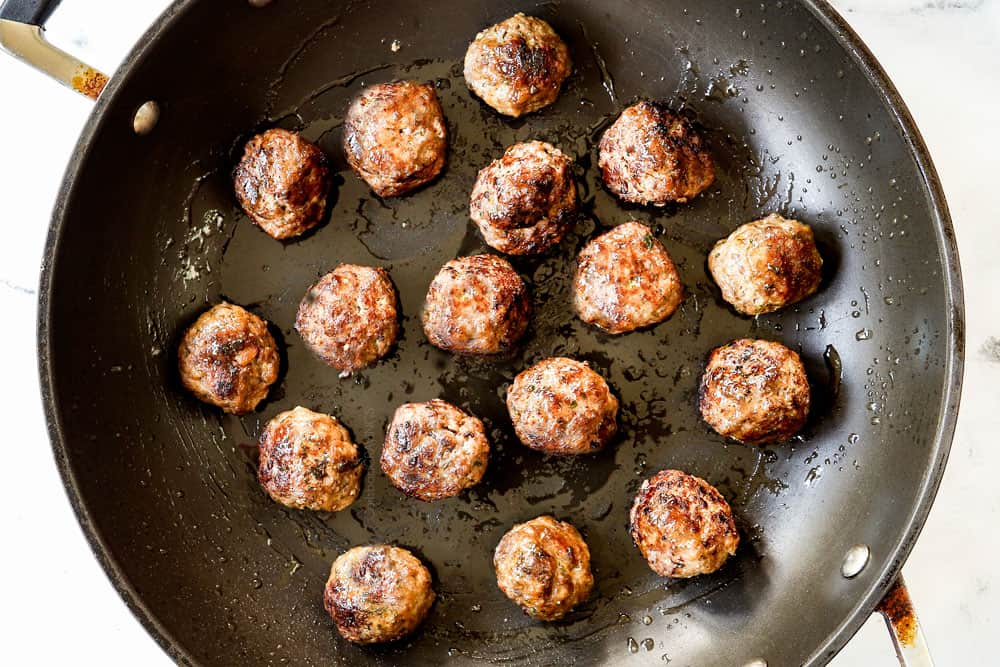 showing how to make Greek Lamb Meatball recipe (Keftedes) by pan frying meatballs in a black nonstick skillet