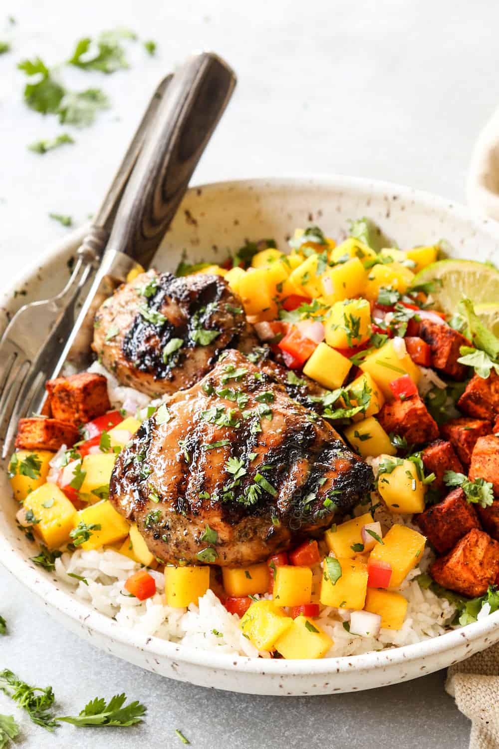 side view of how to serve Jamaican Jerk Chicken served with coconut rice and mango salsa