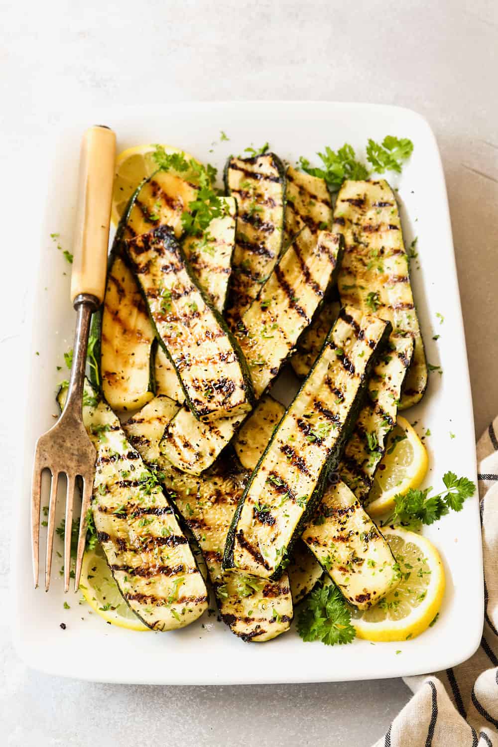 front view of grilled zucchini recipe garnished by lemon