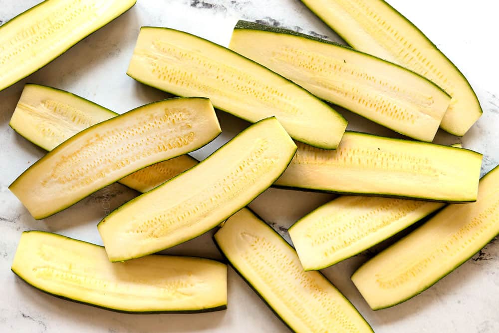 showing how to grill zucchini by slicing it lengthwise into planks
