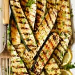 top view of grilled zucchini on a white platter
